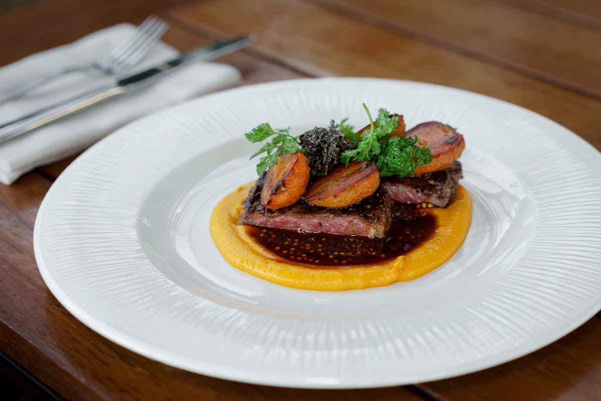 a plate of food sitting on top of a wooden table