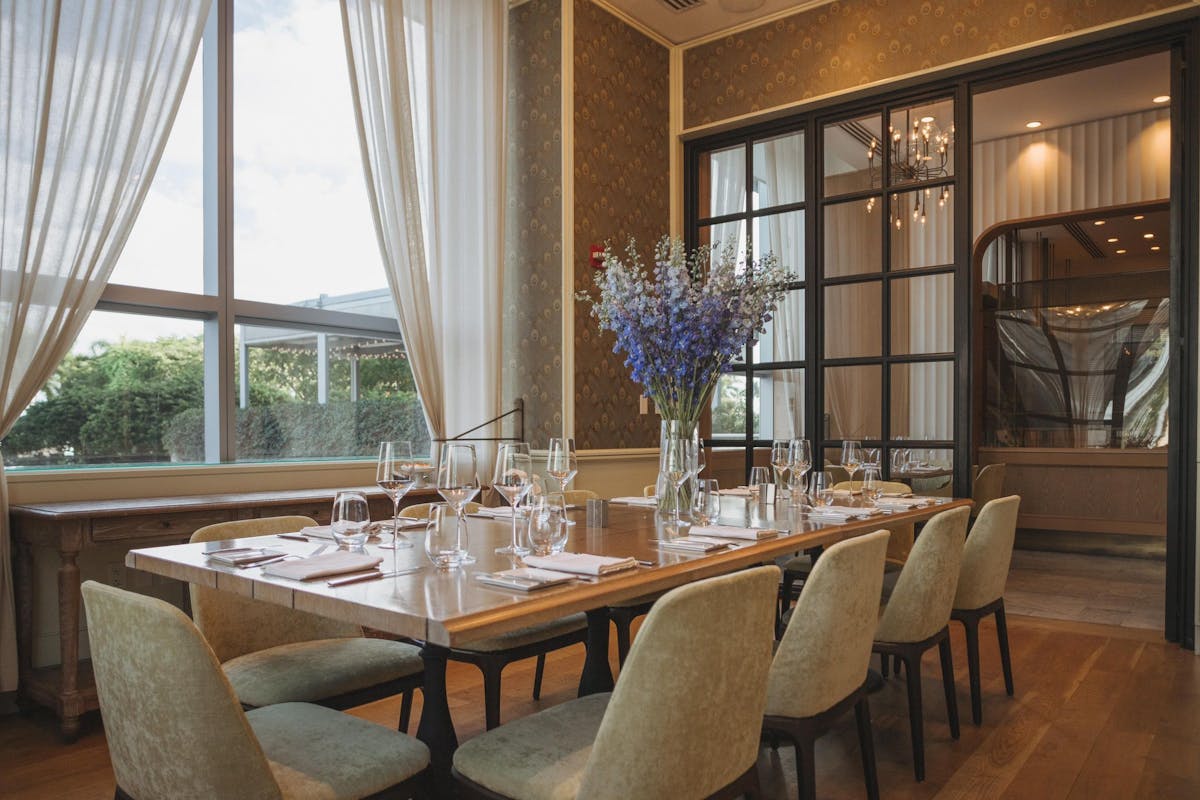 a dining room table in front of a window