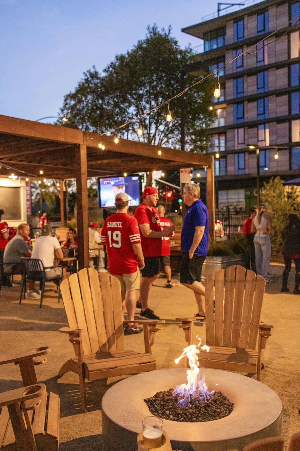 a group of people sitting at a table in front of a building