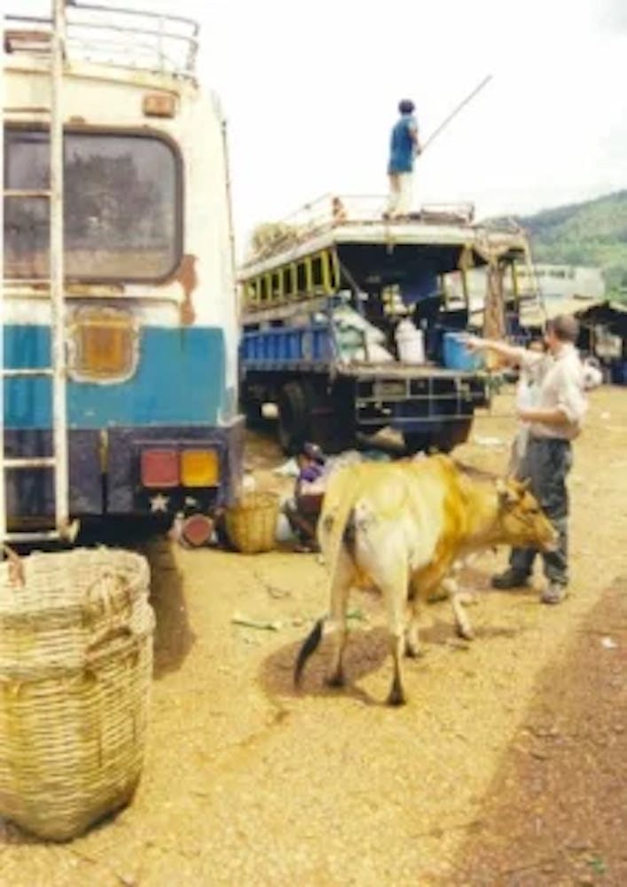 a truck driving down a dirt road