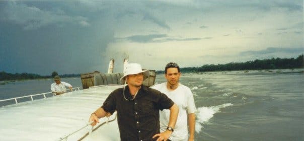 a man standing next to a body of water