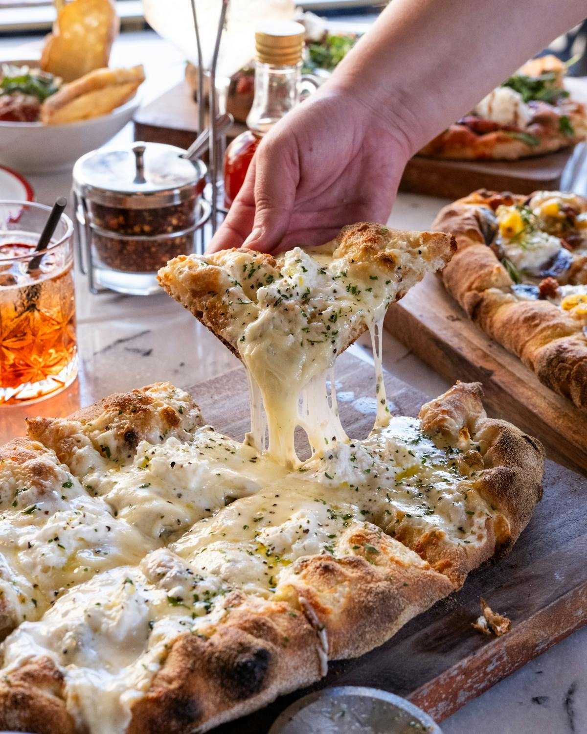 a person sitting at a table with plates of food