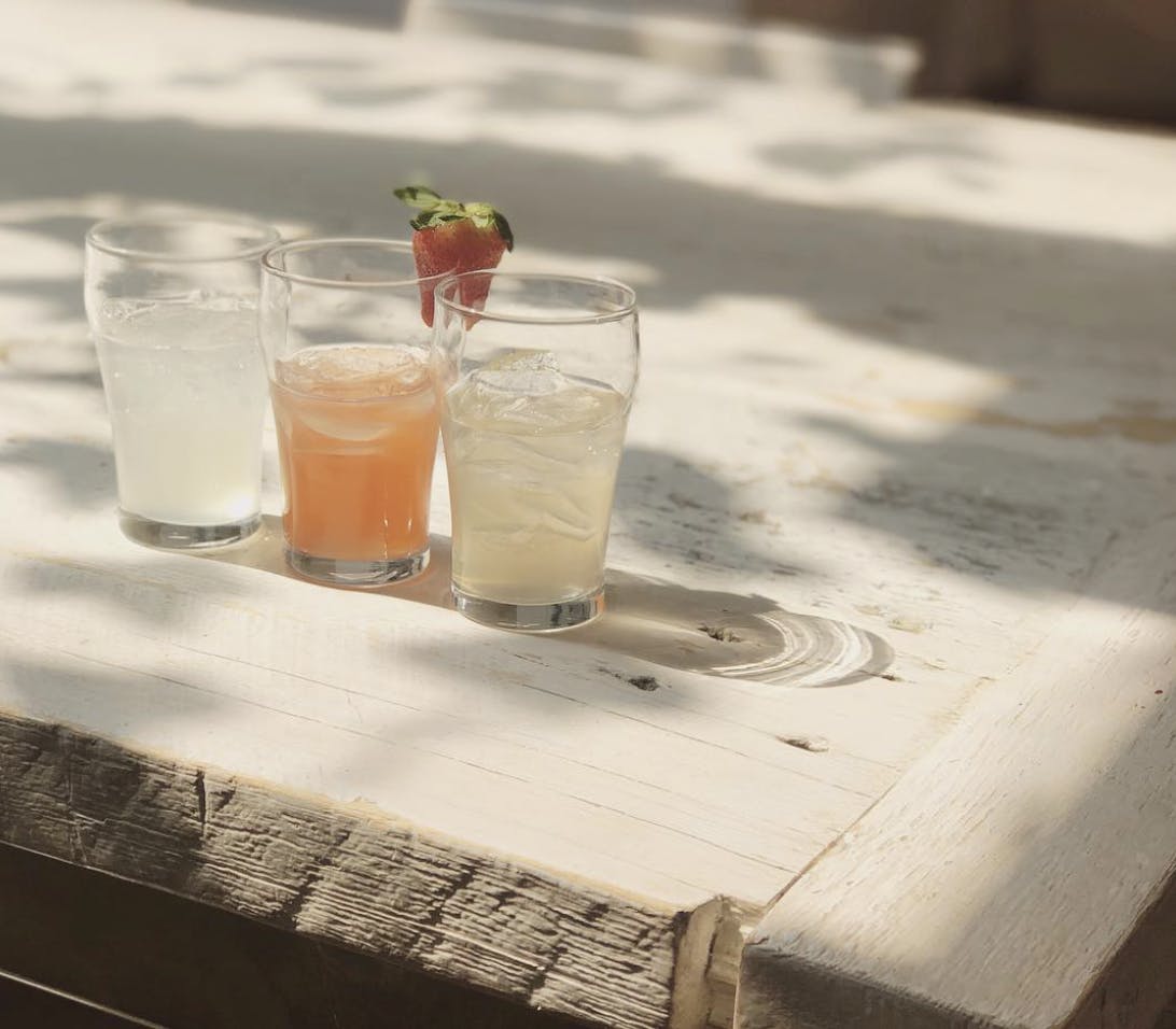 Three glasses of sodas on a table