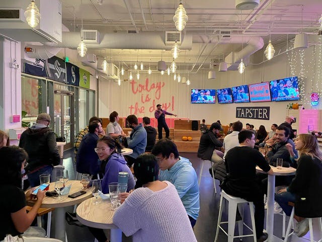 a group of people sitting at a table in a restaurant