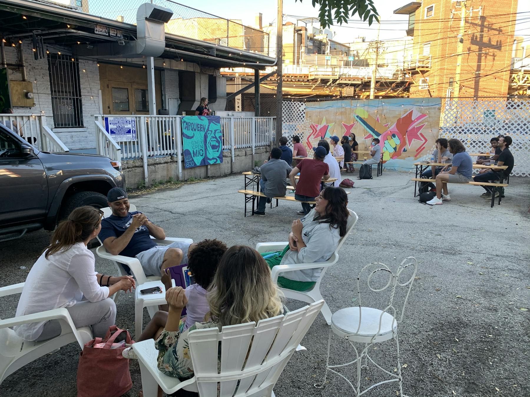 a group of people sitting at a table in front of a building