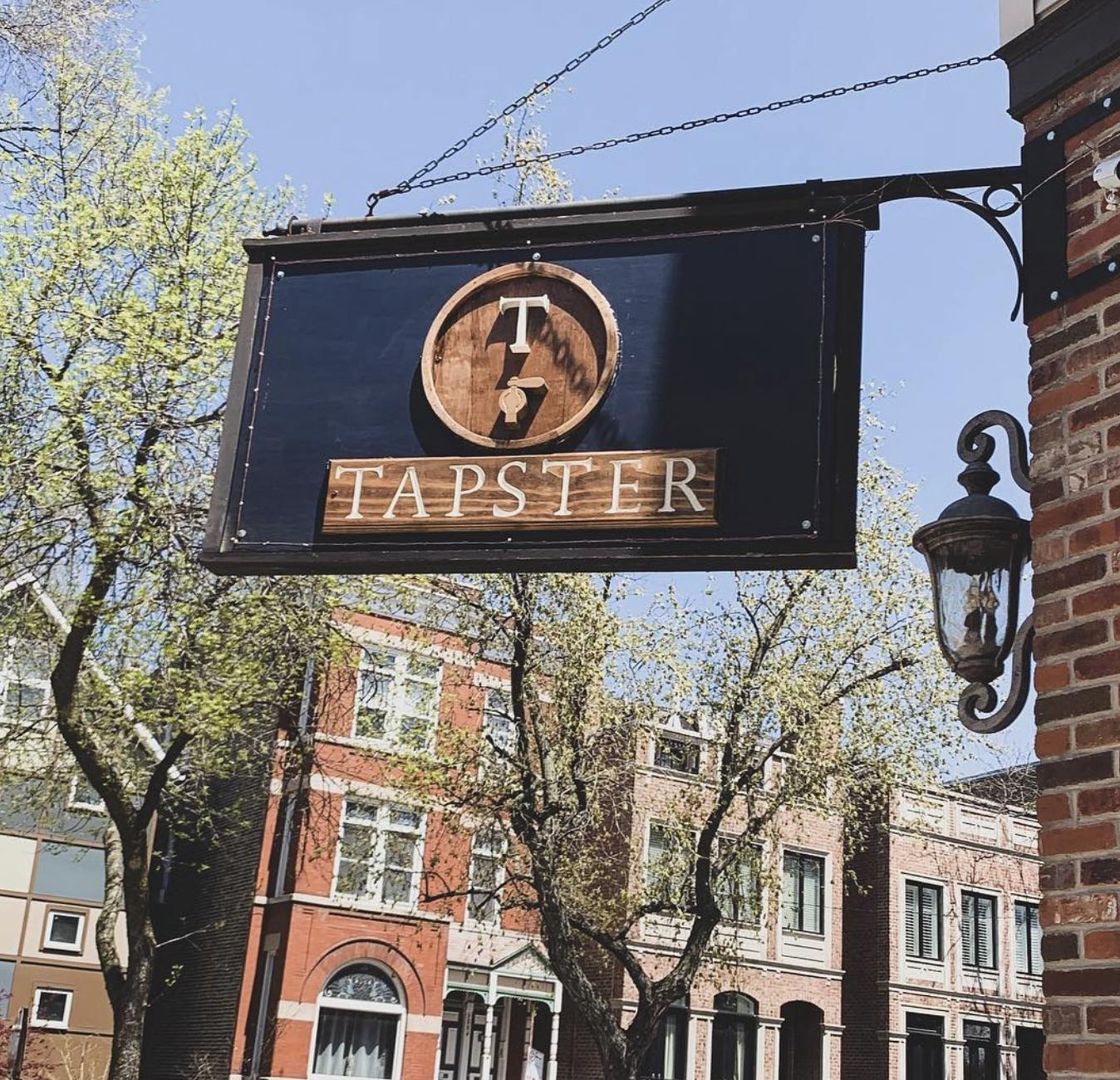 Tapster street sign hanging off the side of a building.