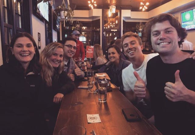 a group of people sitting at a table with wine glasses