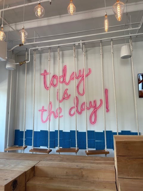 a room that has a sign on a wooden table