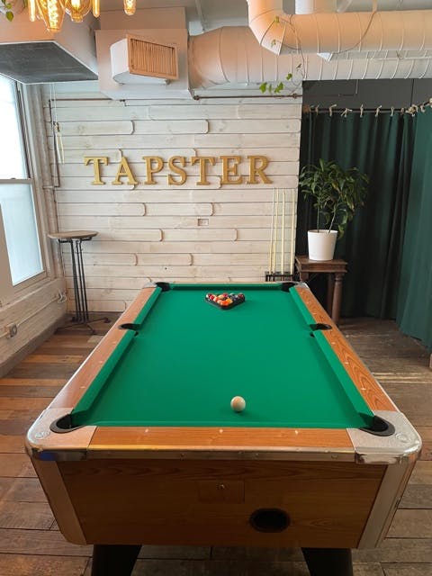 a green ball on a wooden table