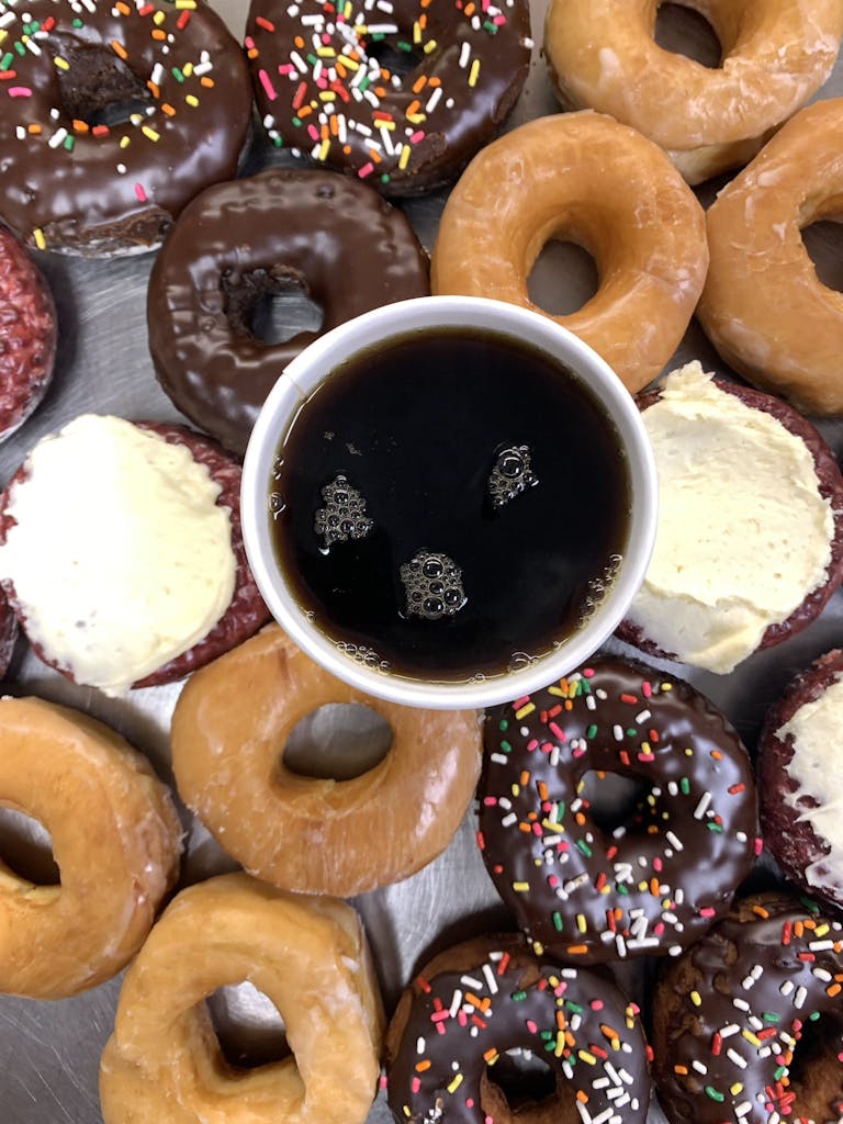 a chocolate doughnut and a cup of coffee