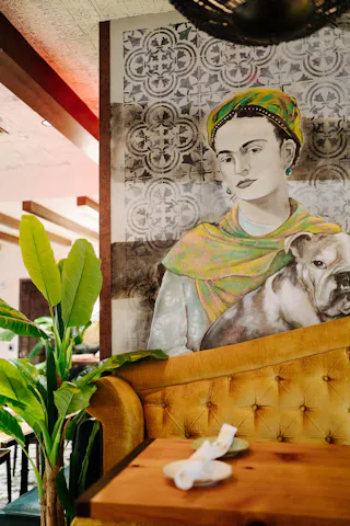 A booth and mural at Yellow Door Taqueria South End