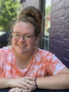 a person sitting in front of a building