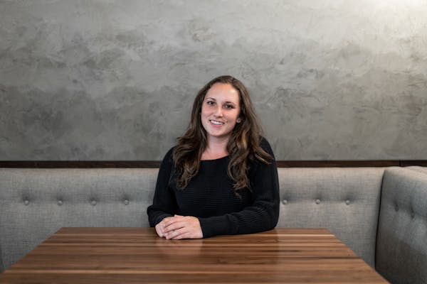 a woman sitting on a bench posing for the camera