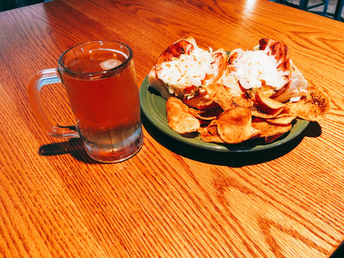 a plate of food and a glass of beer on a table