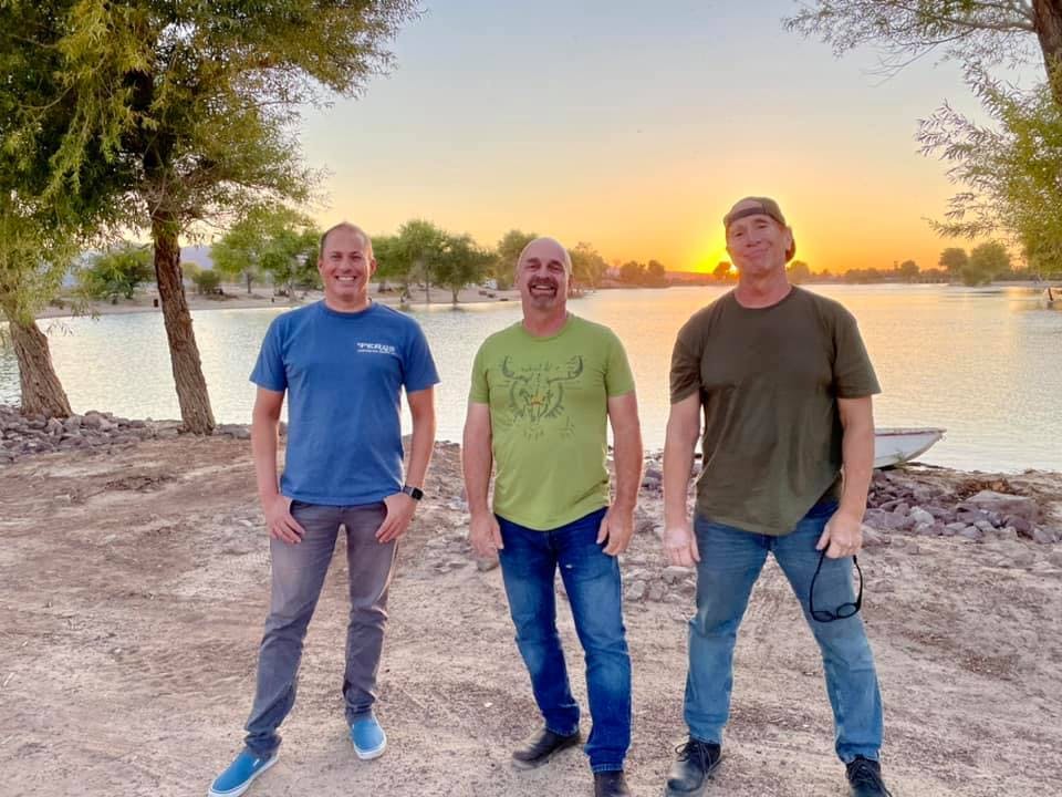 a group of people standing next to a tree