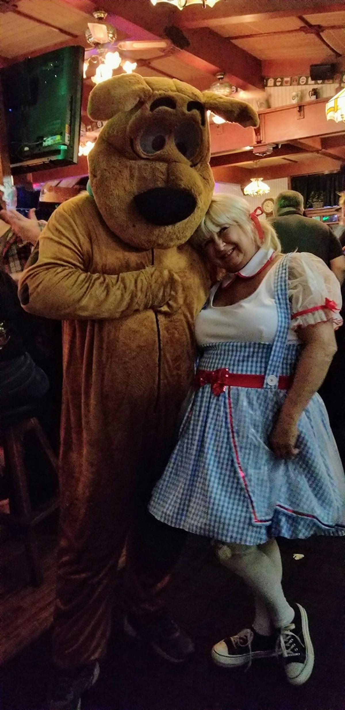 a group of people looking at a teddy bear