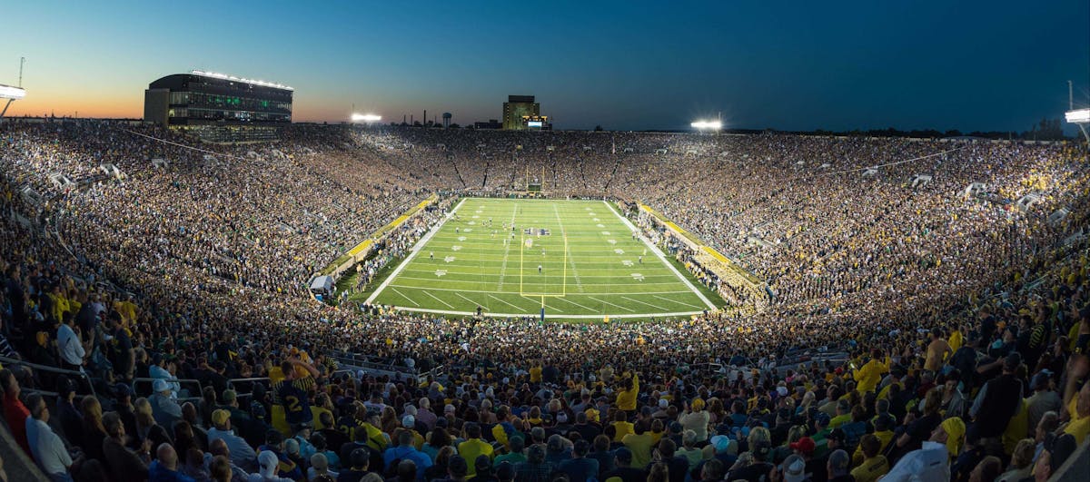 a stadium full of people with Michigan Stadium in the background