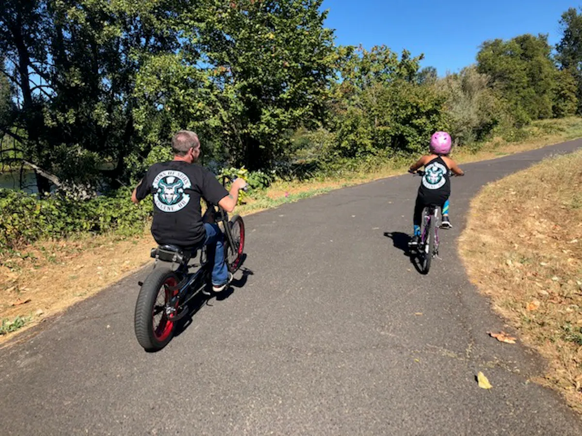 a couple of people riding on the back of a motorcycle