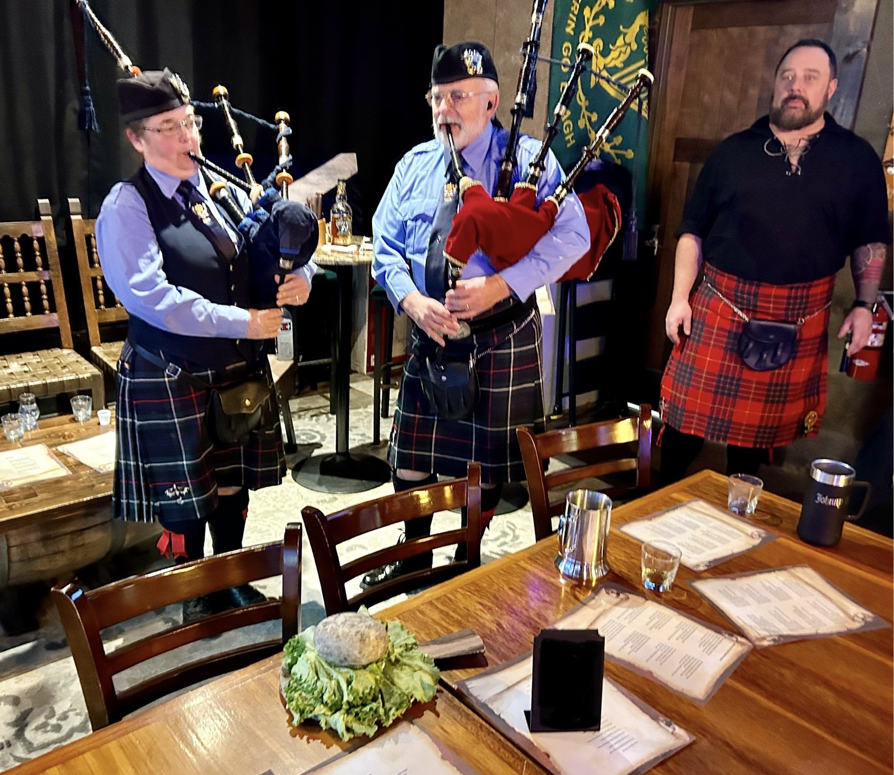 a group of people standing around a table