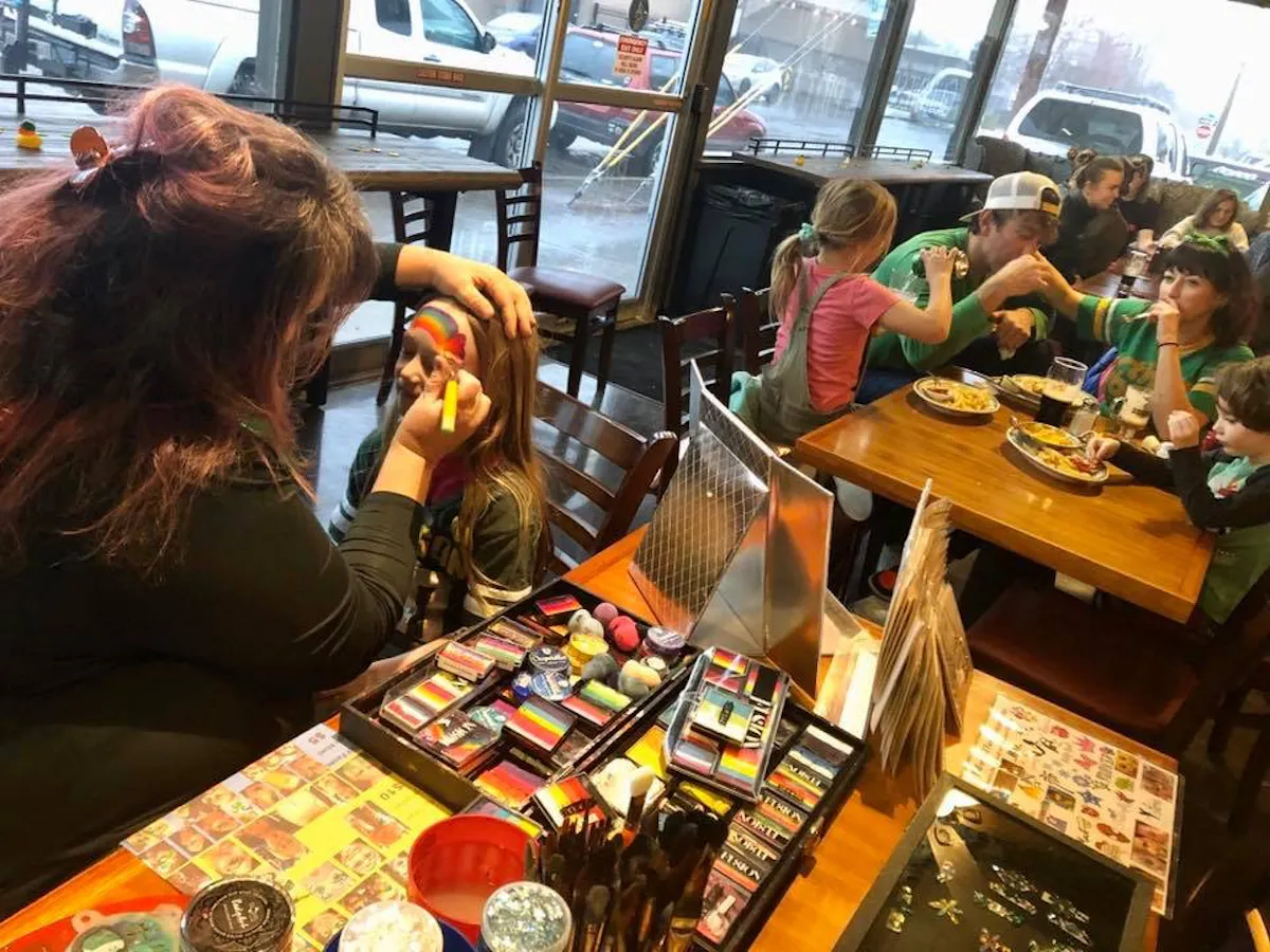 a woman sitting at a table eating food