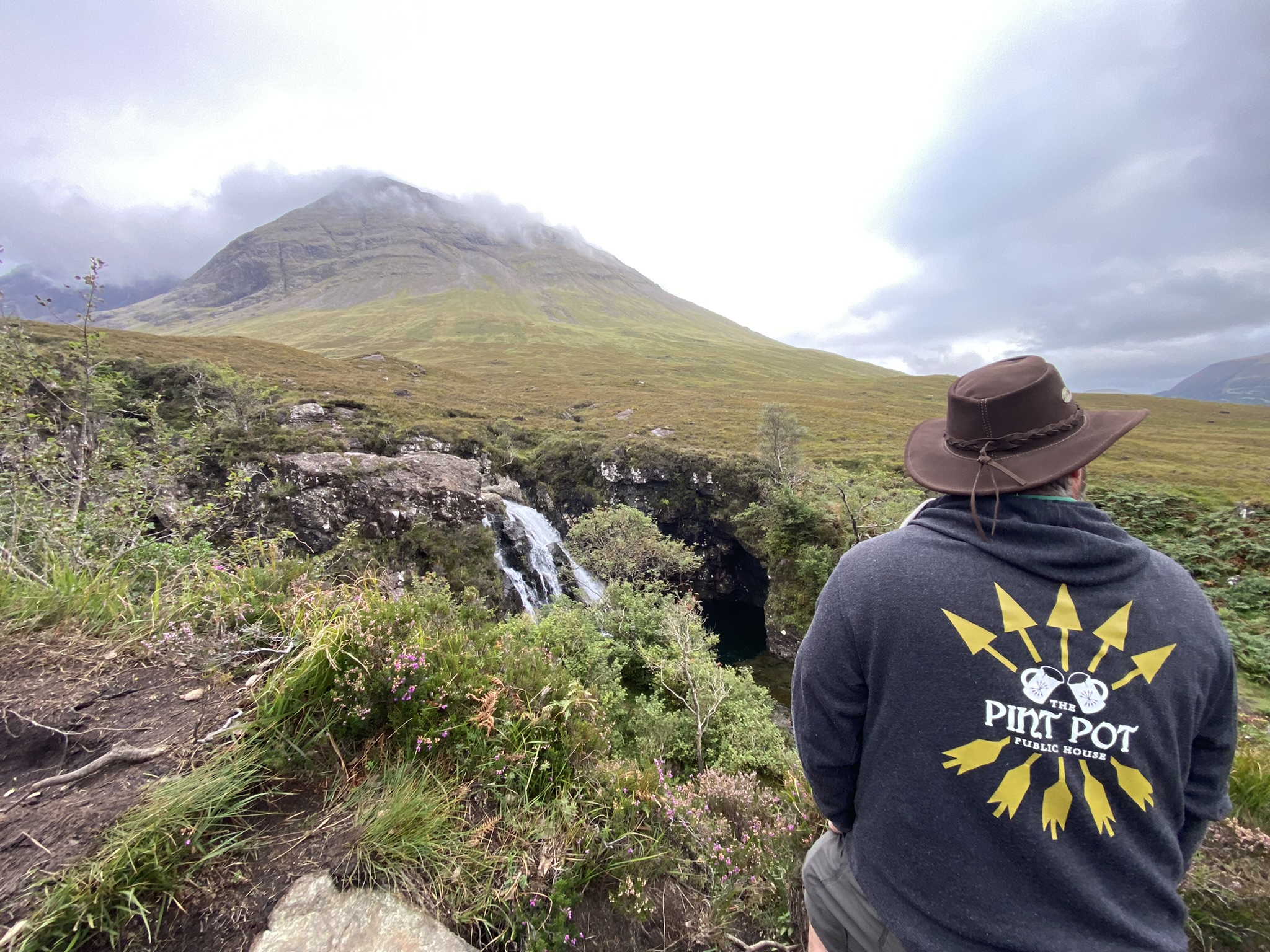 a man standing in front of a mountain