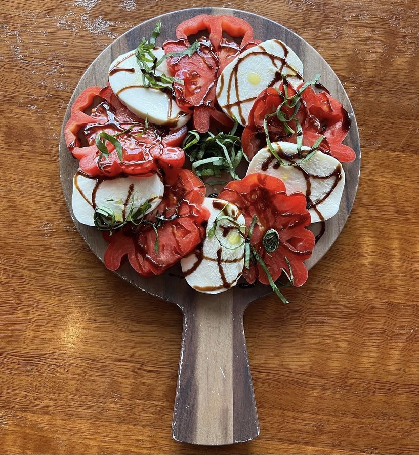 a pizza sitting on top of a wooden cutting board
