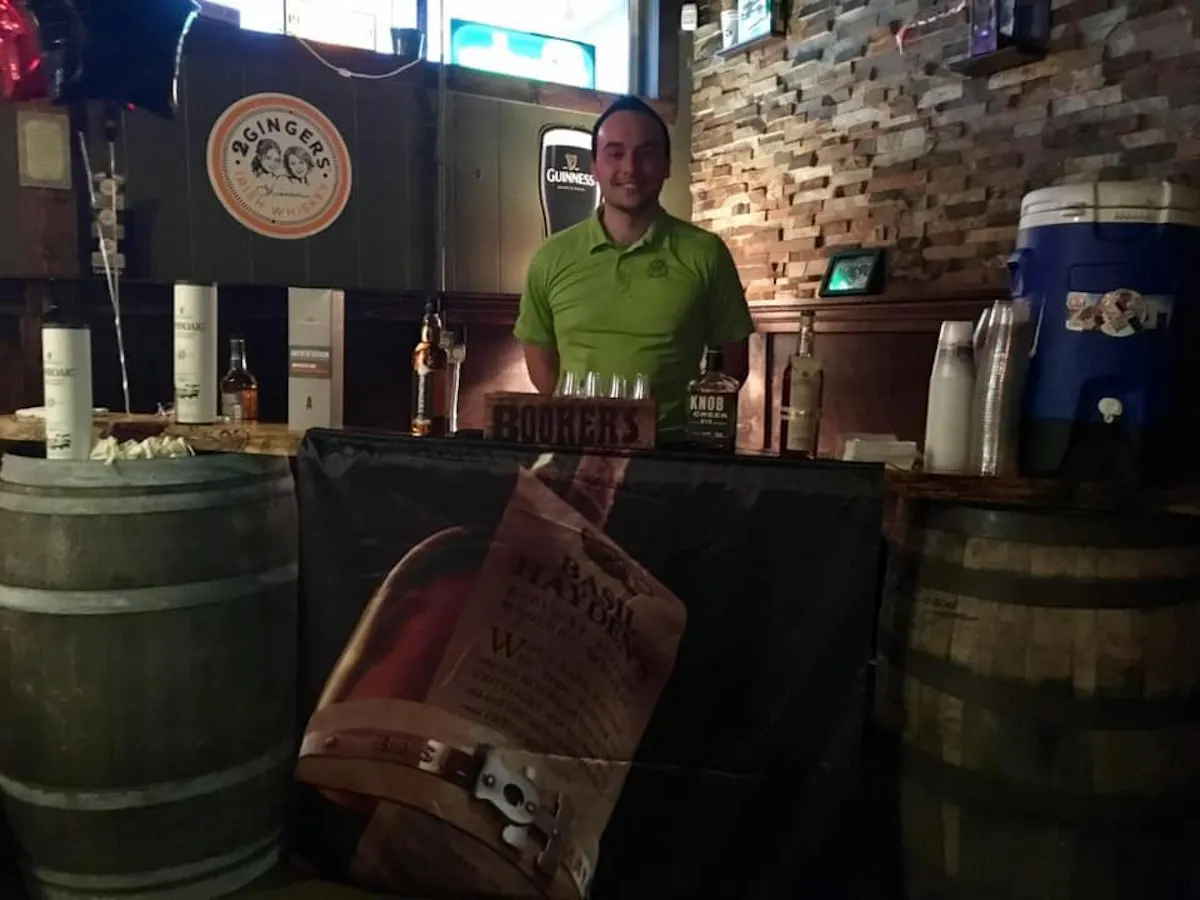 a man standing in front of a barrel