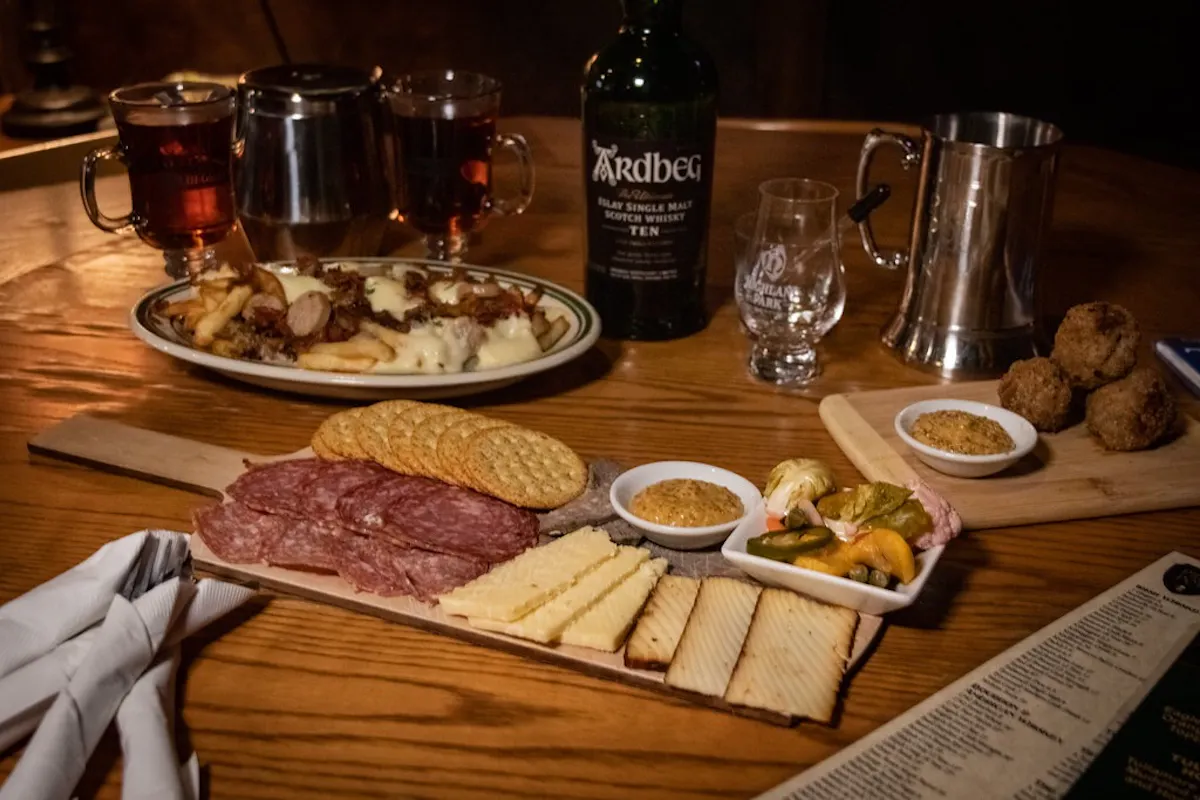 a plate of food sitting on top of a wooden cutting board