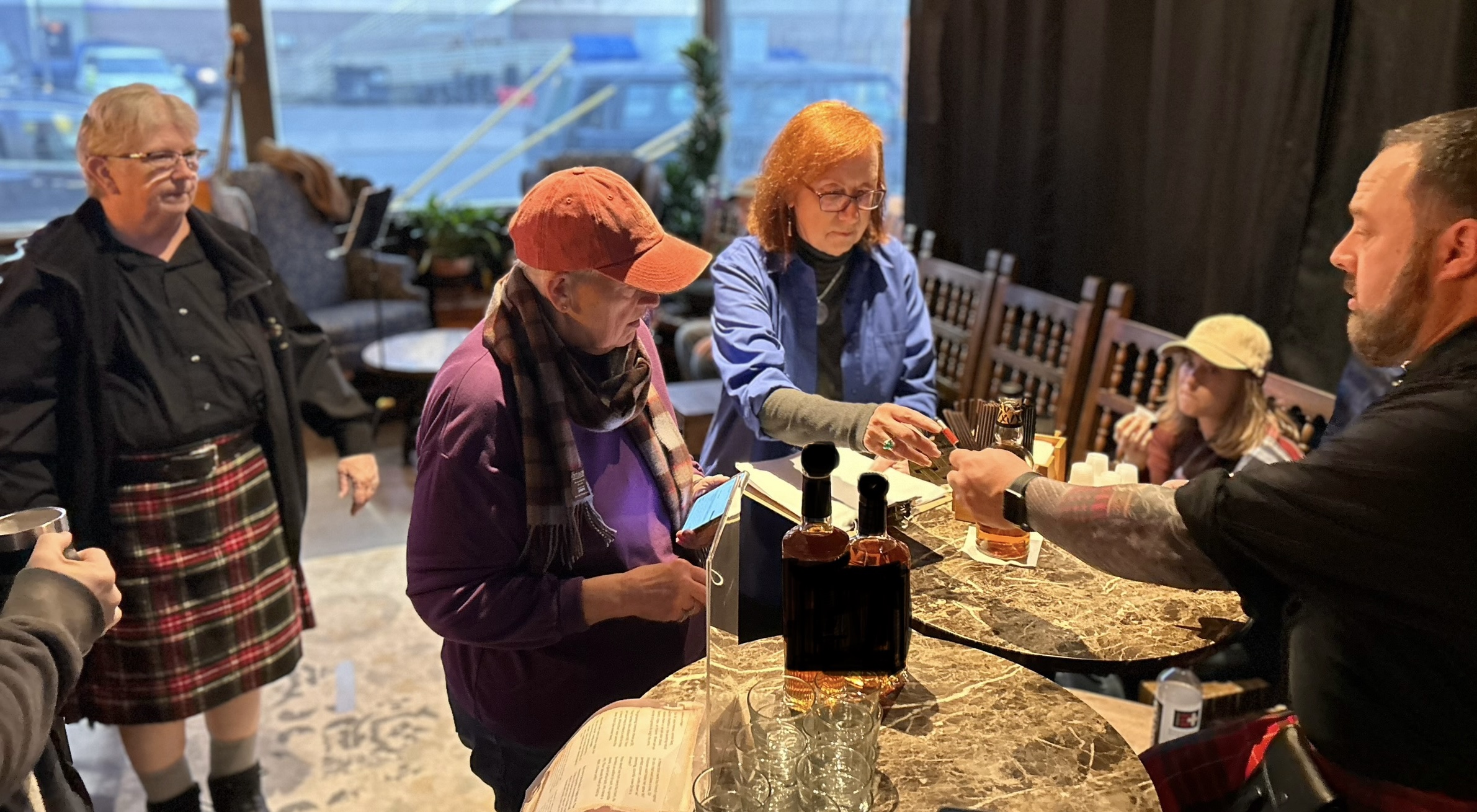 a group of people standing around a table