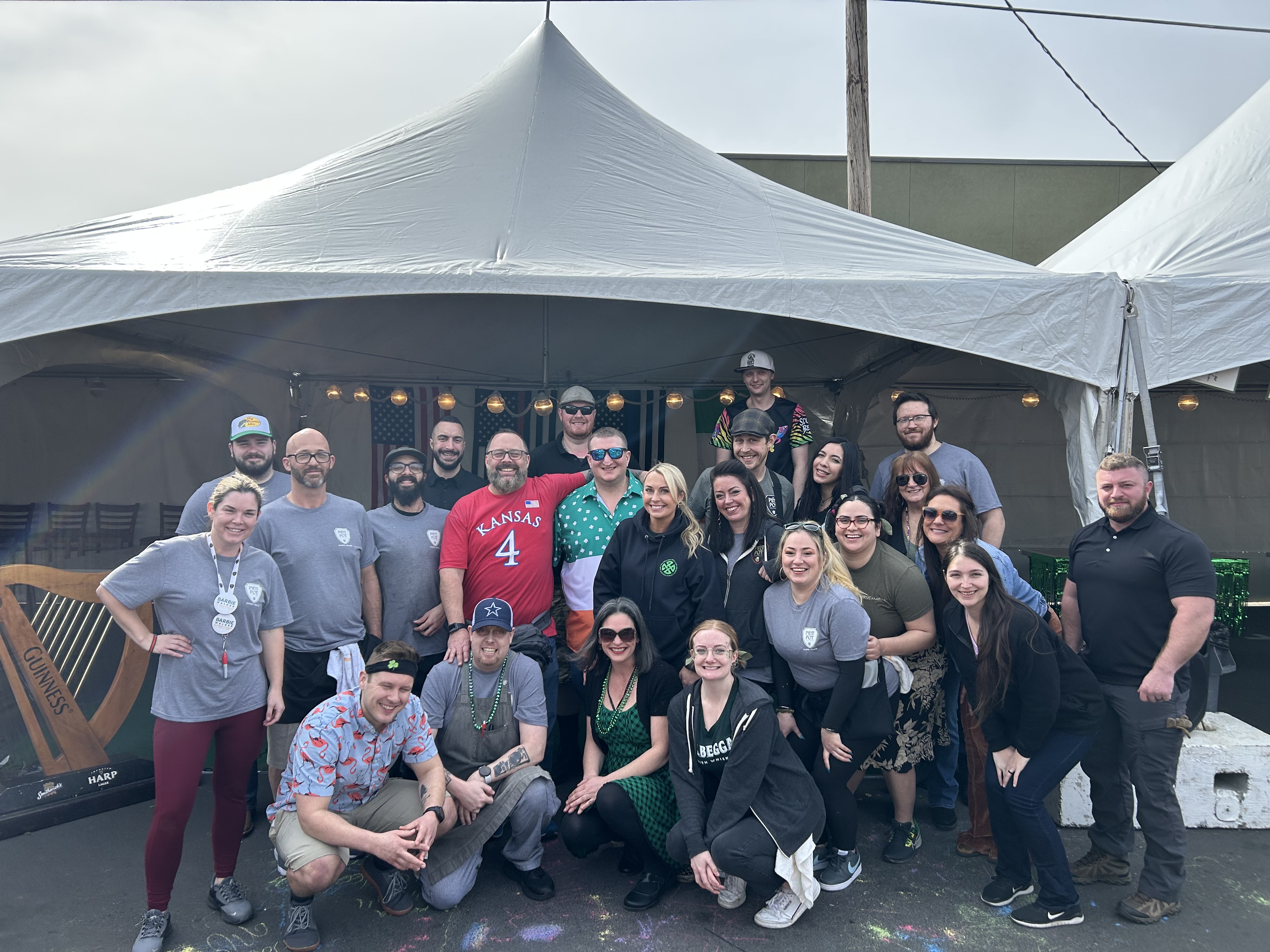a group of people standing in front of a crowd posing for the camera