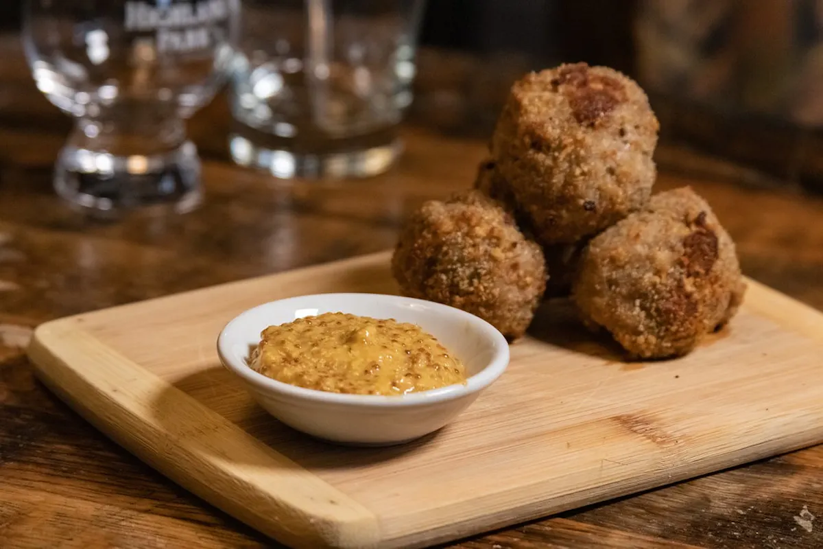 a plate of food sitting on top of a wooden cutting board