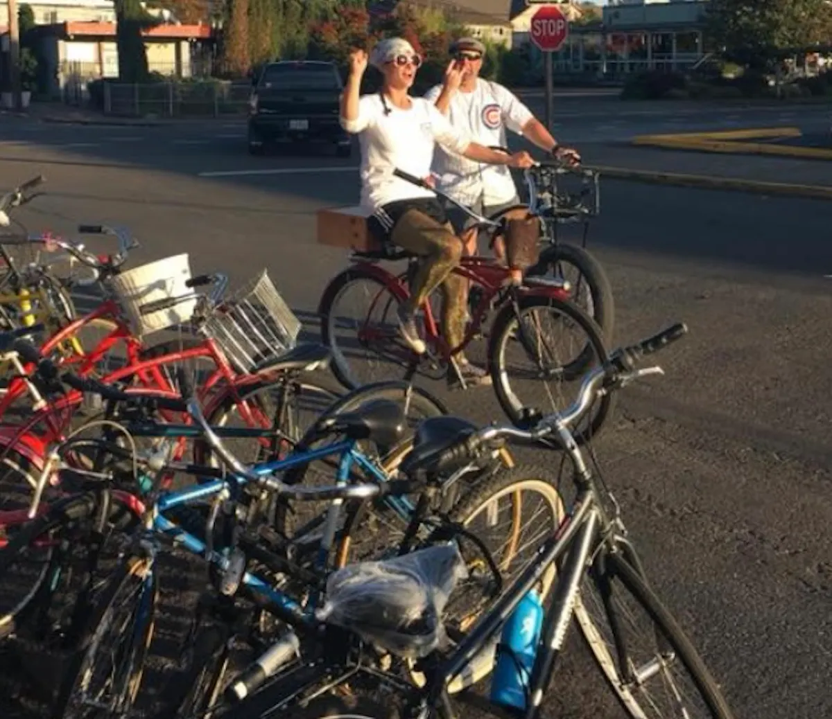 a group of people riding on the back of a bicycle