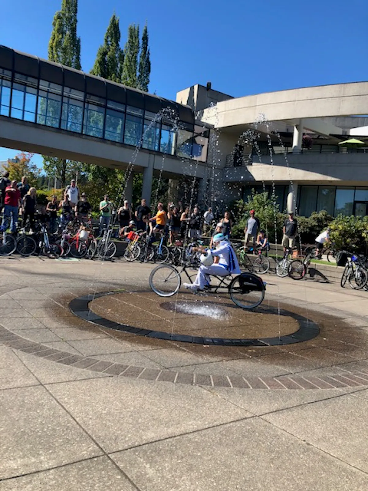a group of people on a motorcycle in front of a building
