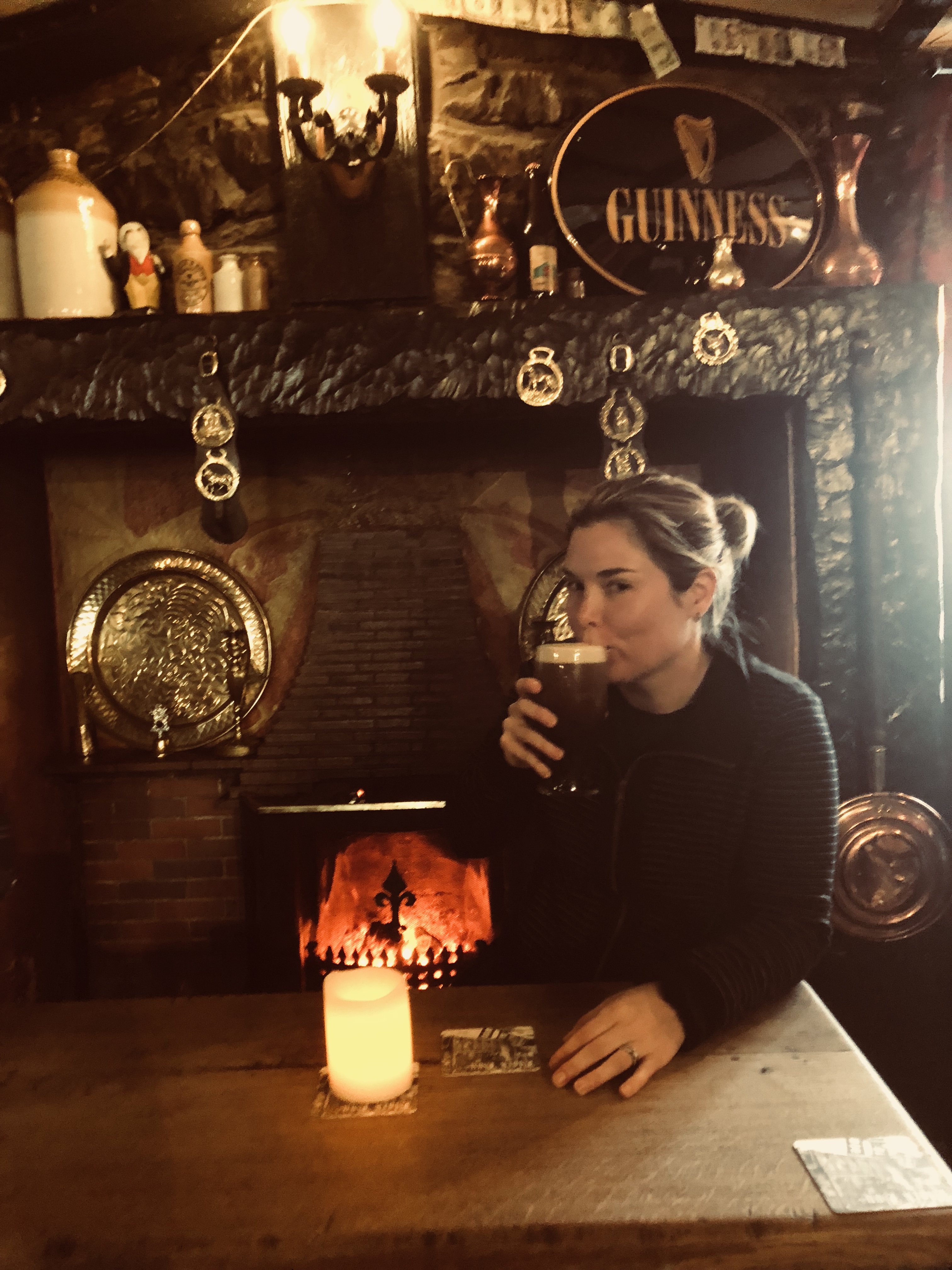 a person sitting at a table in front of a fireplace