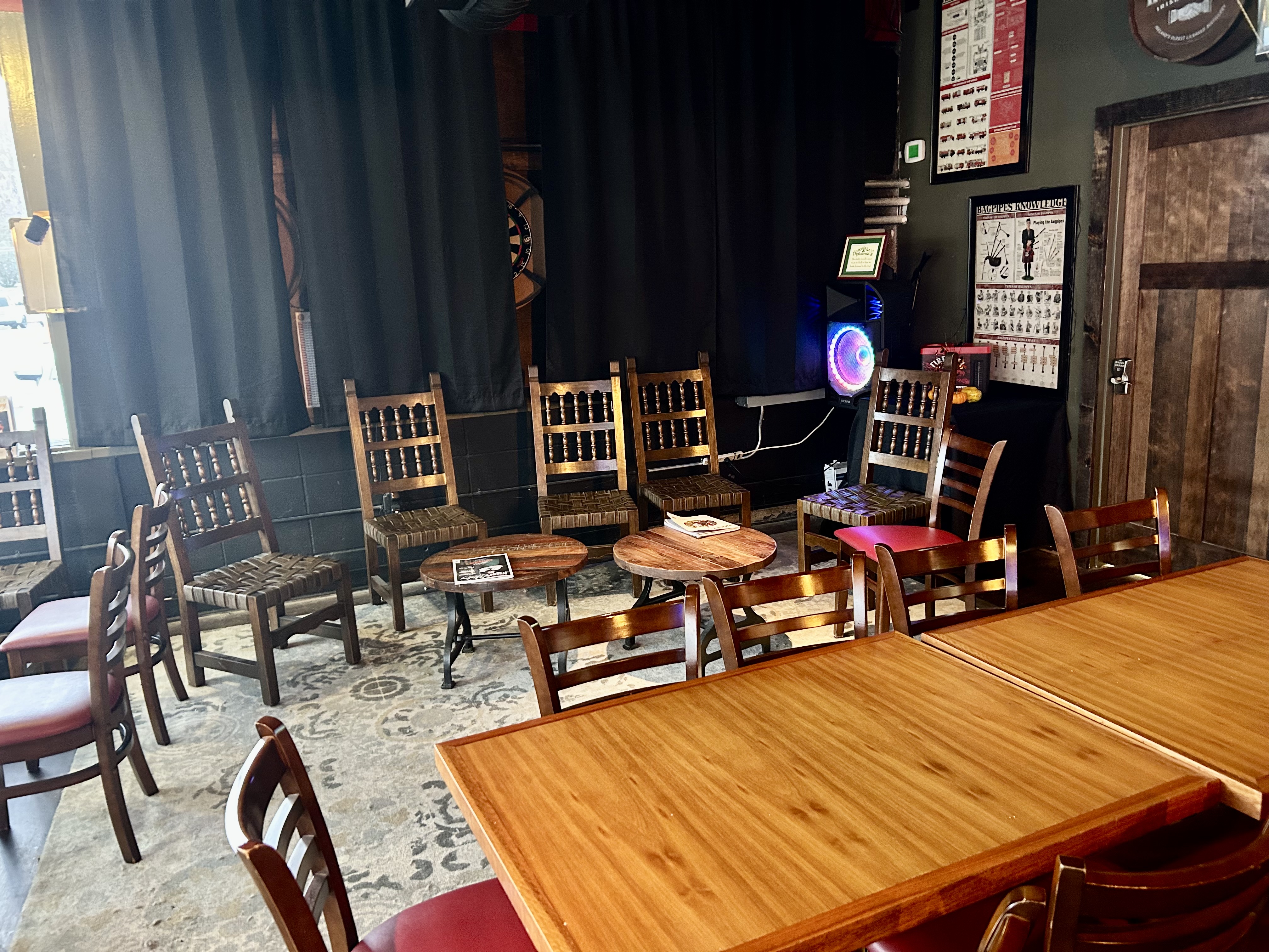 a group of people sitting around a wooden table