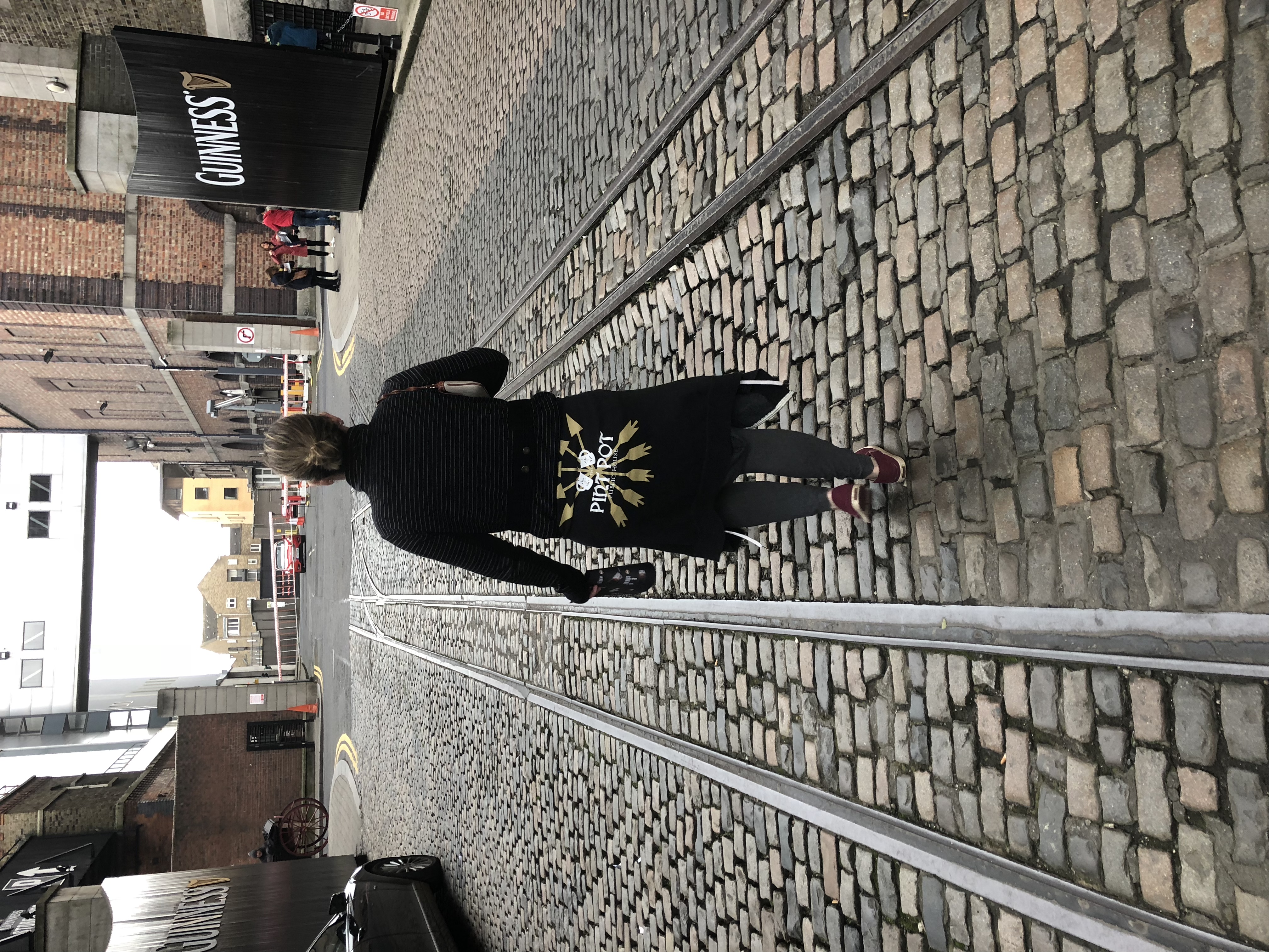 a person standing in front of a brick building