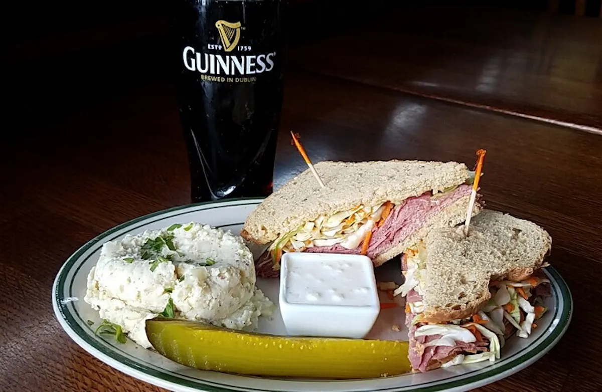 a sandwich sitting on top of a plate of food on a table
