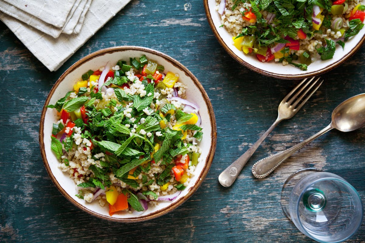 a bowl of food sitting on top of a wooden table