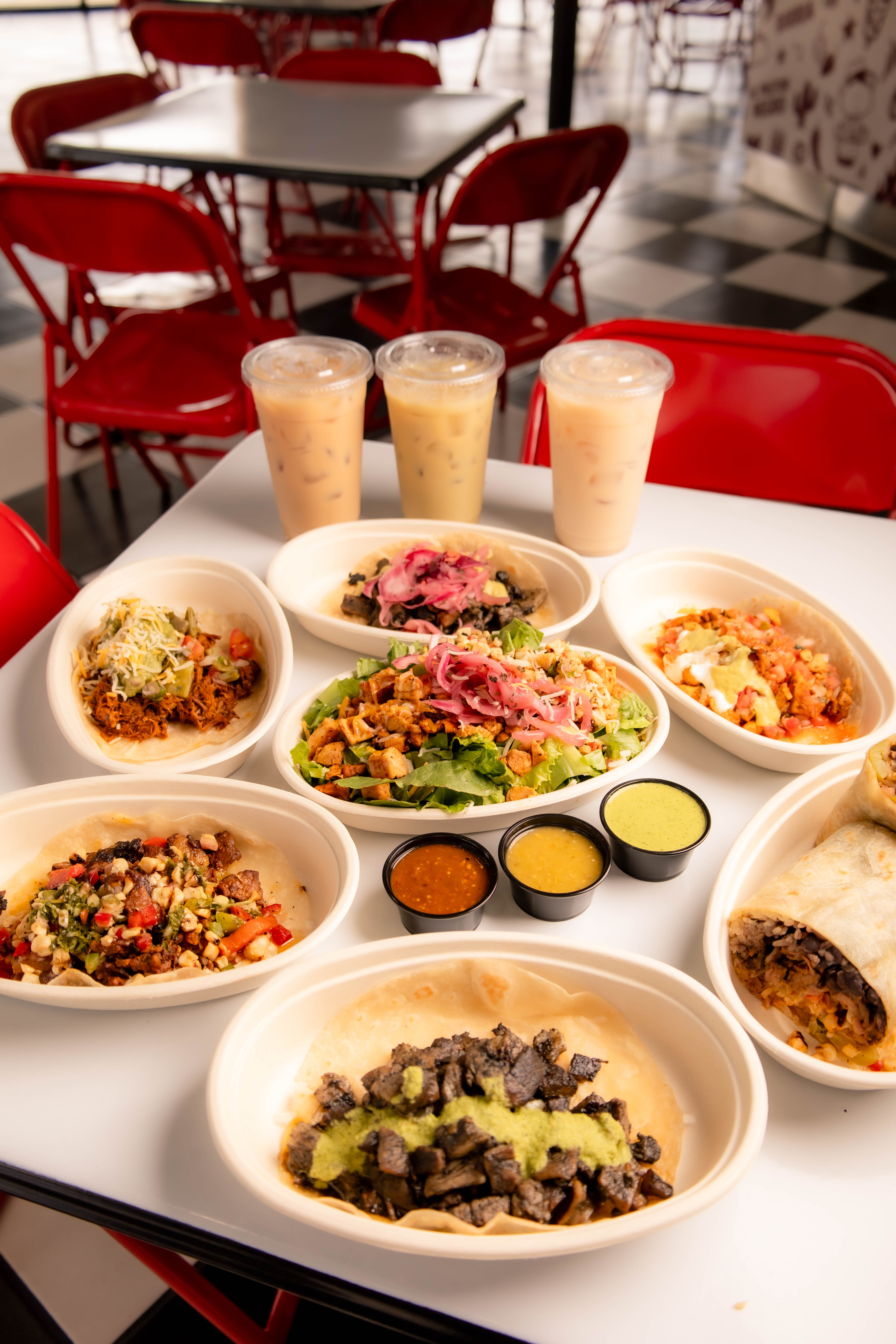 a table with plates of food and drinks
