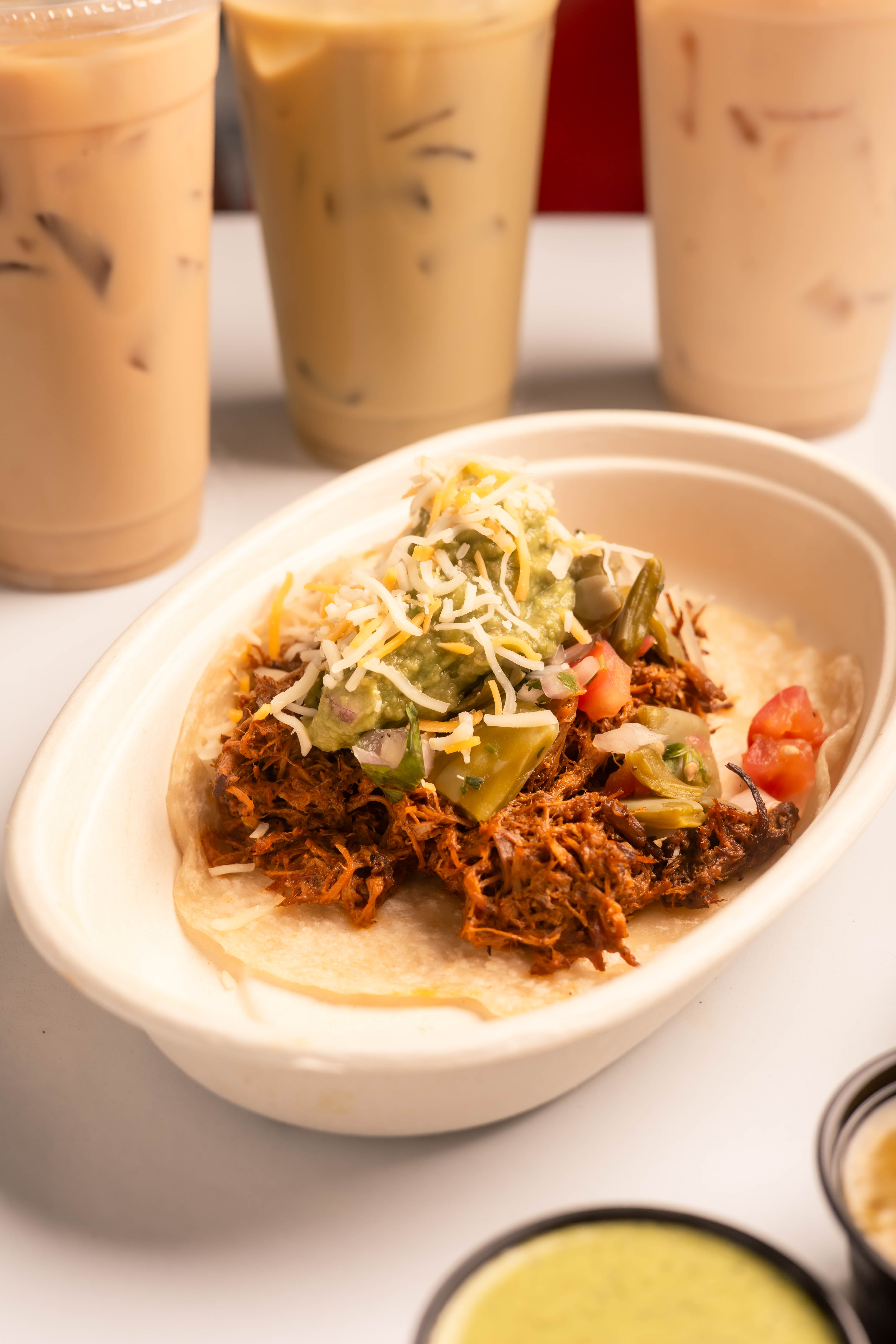 a bowl of food with a few cups of coffee