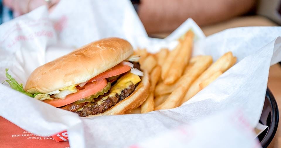 a hamburger and chips on a plate