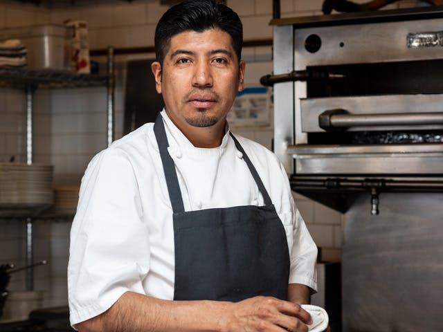 a man cooking in a kitchen preparing food