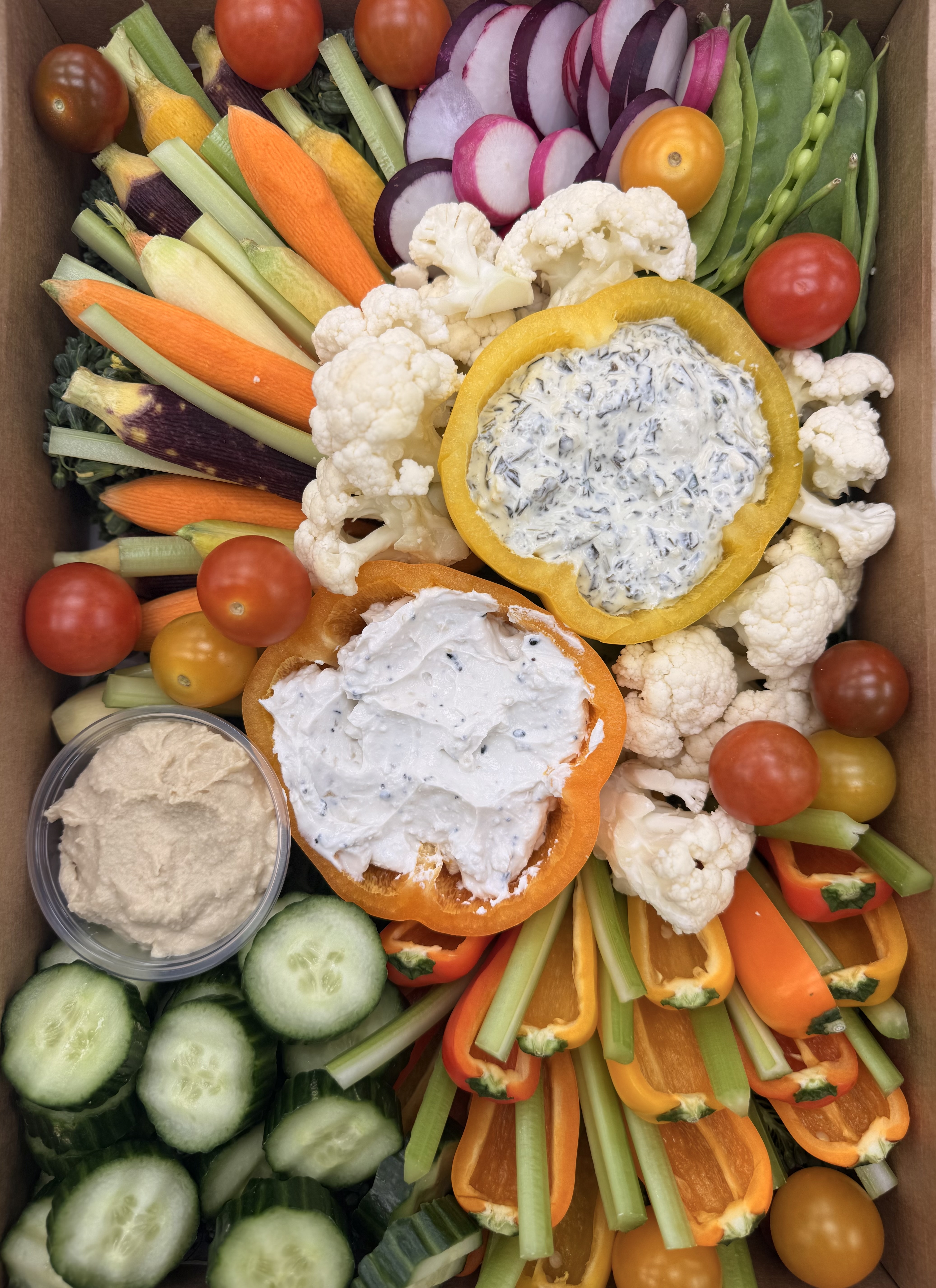 a box of vegetables and dips