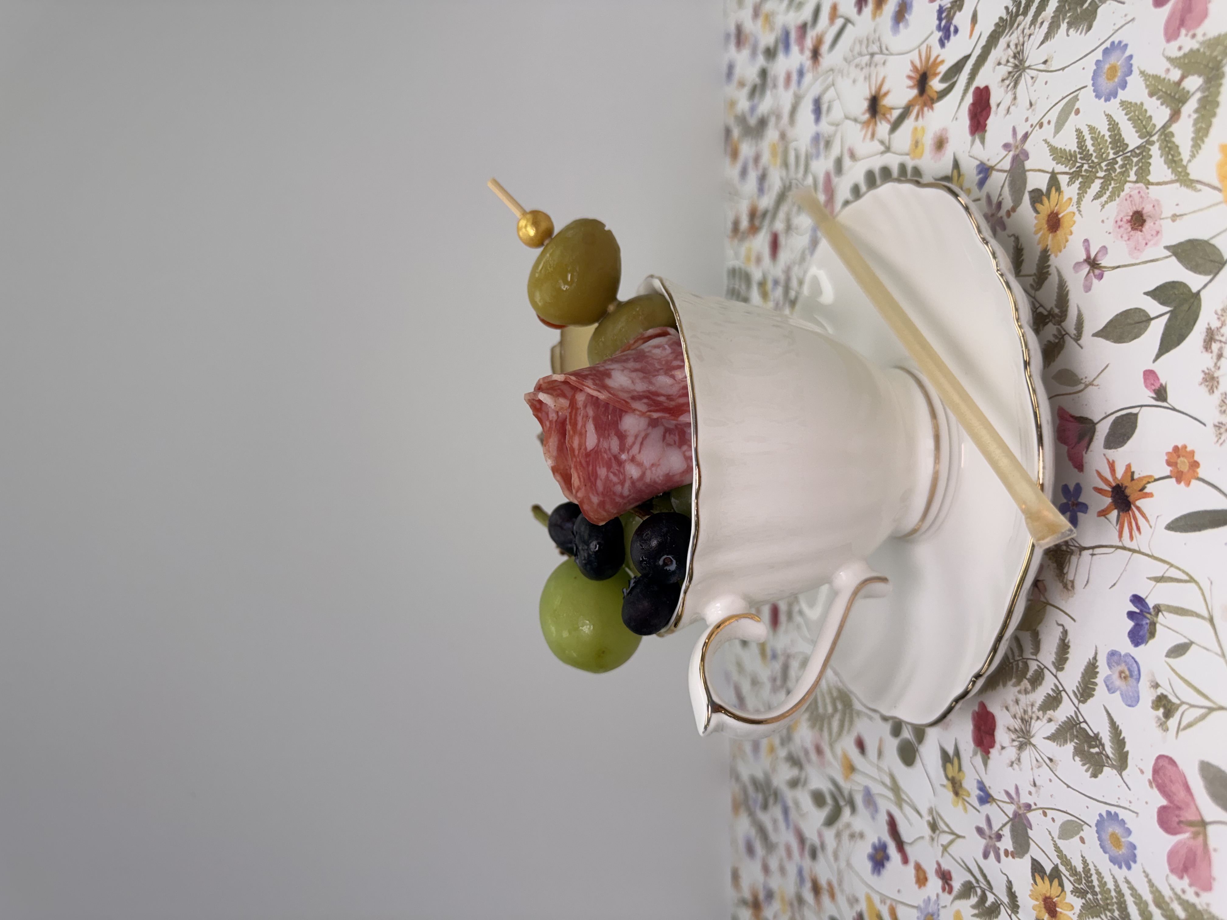 a cup of fruit in a saucer