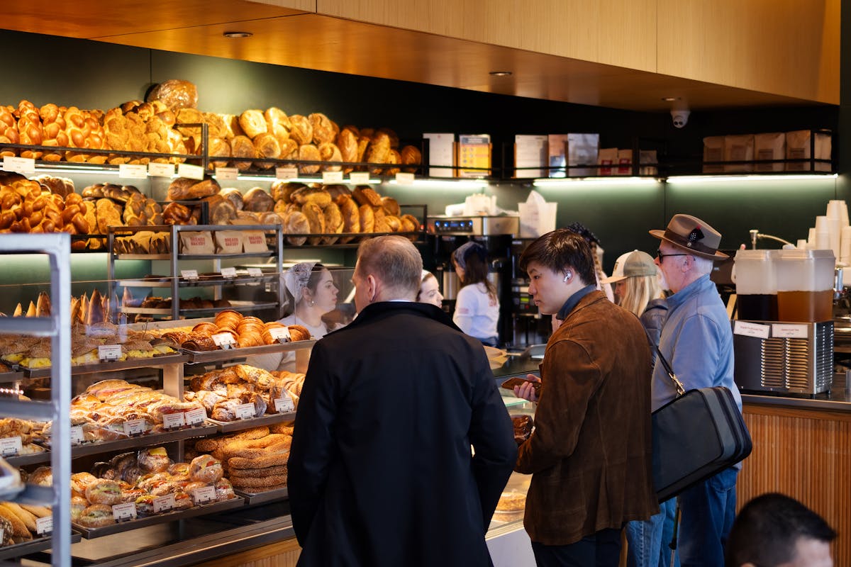 a group of people looking at a donut shop