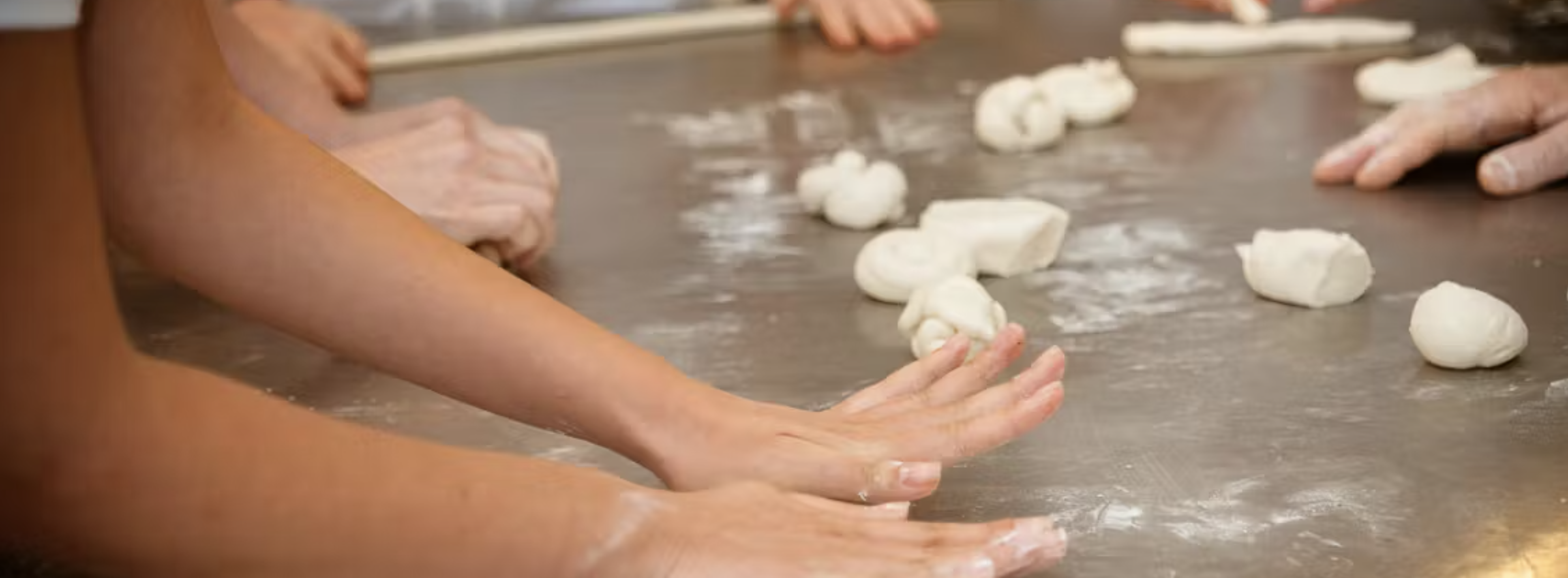 hands on a table with white flour