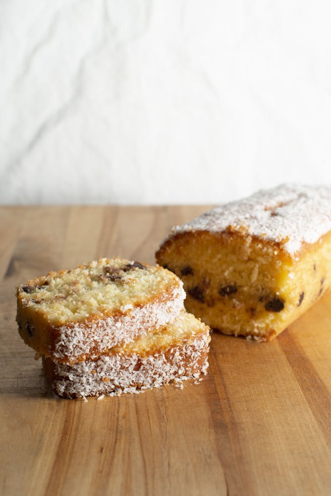 a piece of cake sitting on top of a wooden cutting board