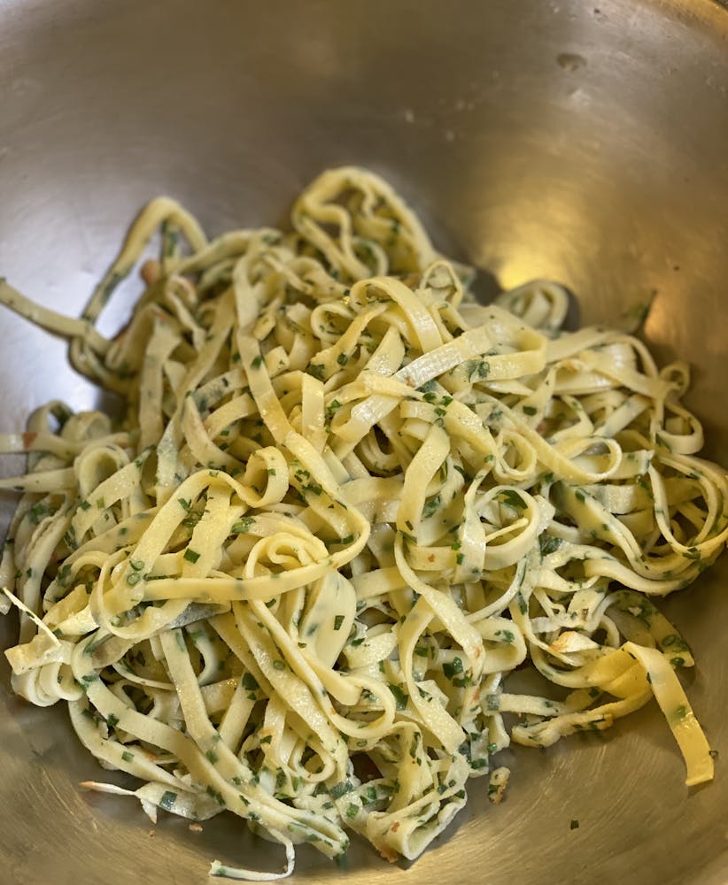 a close up of a bowl of noodles with sauce