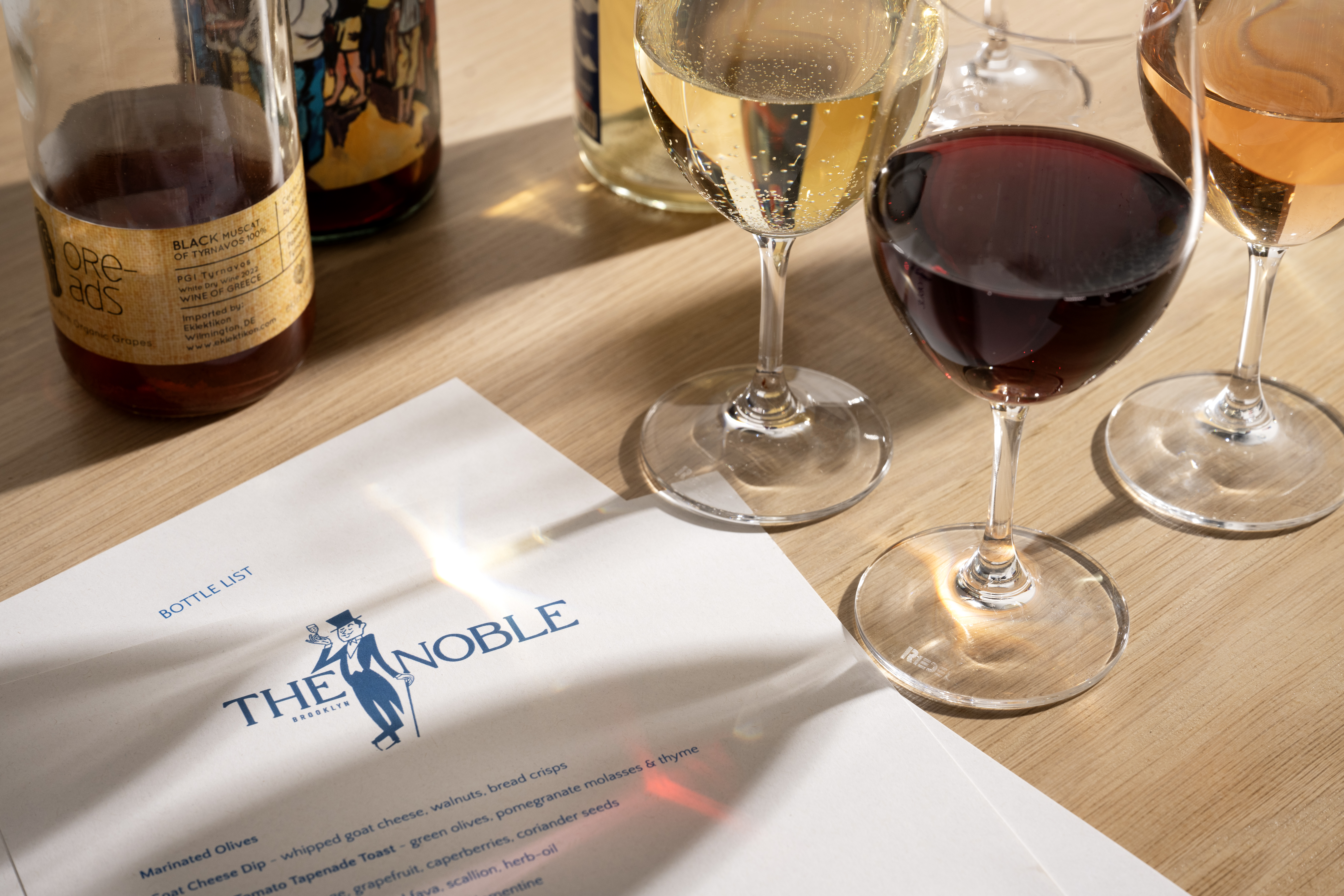 a close up of a bottle and a glass of wine