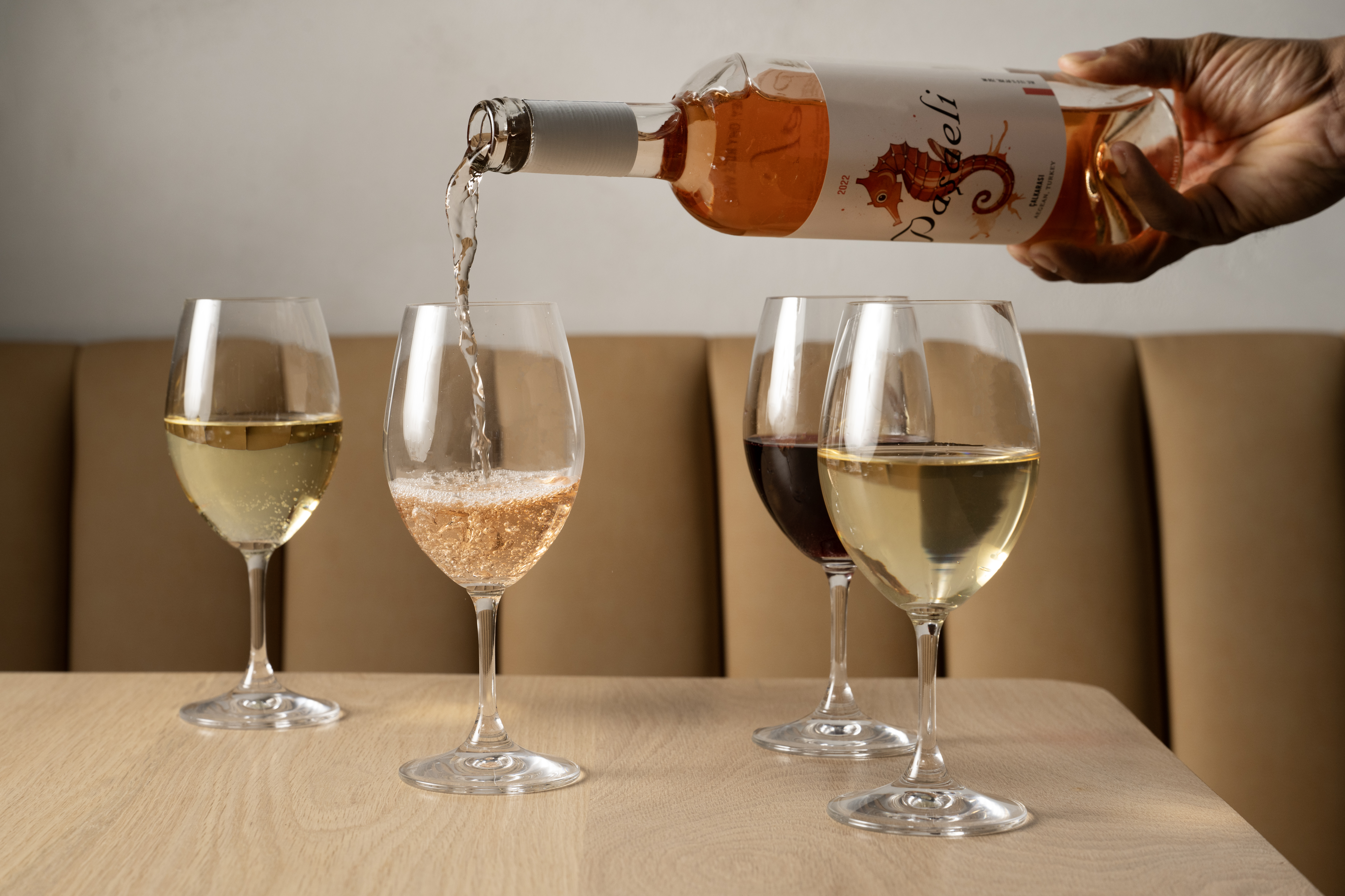 a glass of wine sitting on top of a table